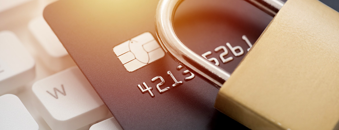 Padlock resting on top of a credit card and keyboard