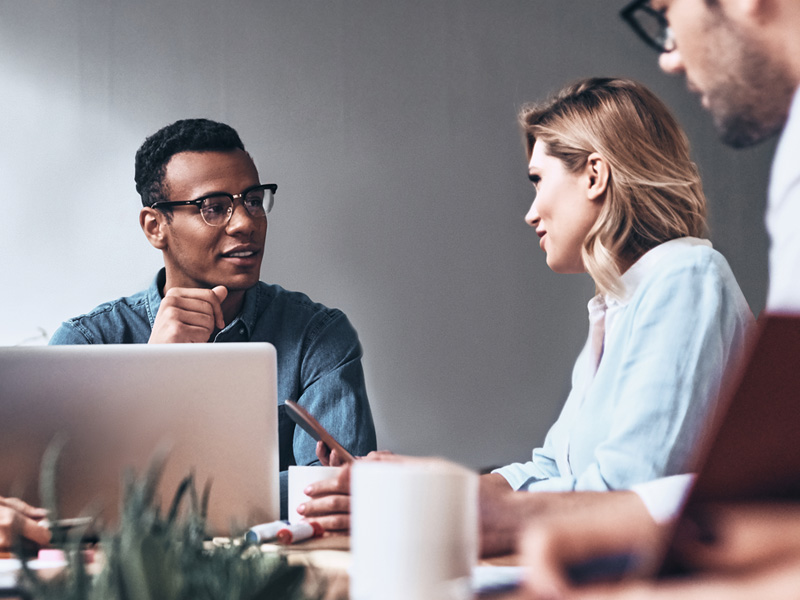 Group of co-workers sitting at a conference room table