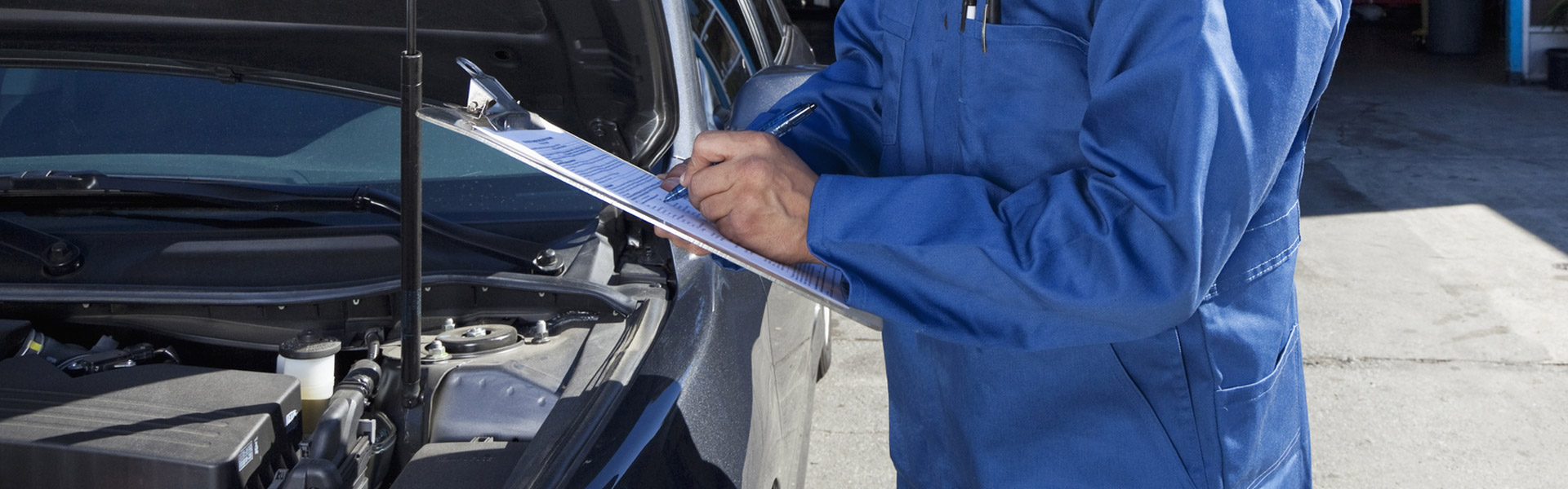 Mechanic assessing car