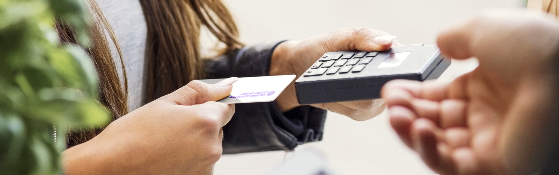 Person paying with debit card at pay station