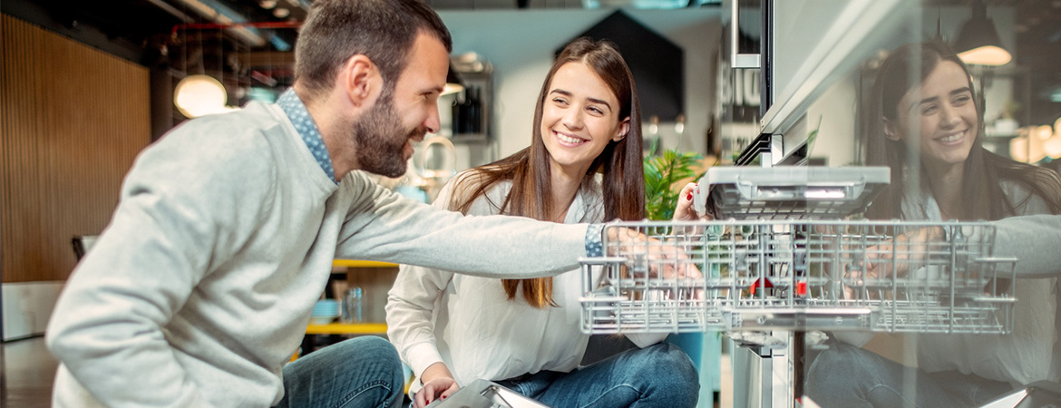 Father and daughter shopping at applicance store for a new dishwasher using funds from a personal loan